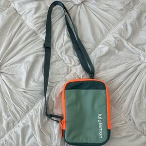 lululemon cross body in teal green with orange border
